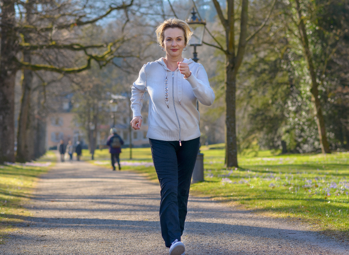 fit, mature woman showing what the daily walking habit does to your body