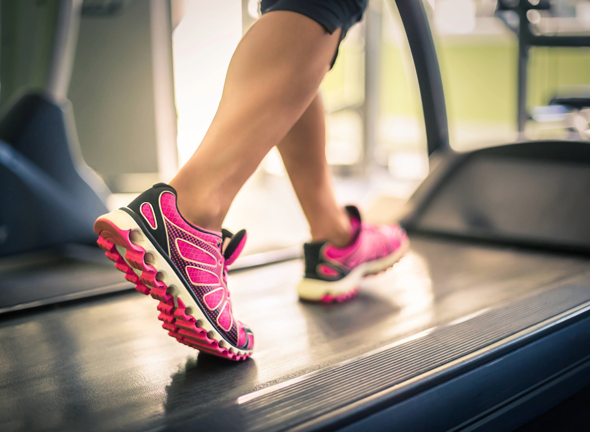 woman walking on a treadmill, concept of how fast to walk on a treadmill for weight loss