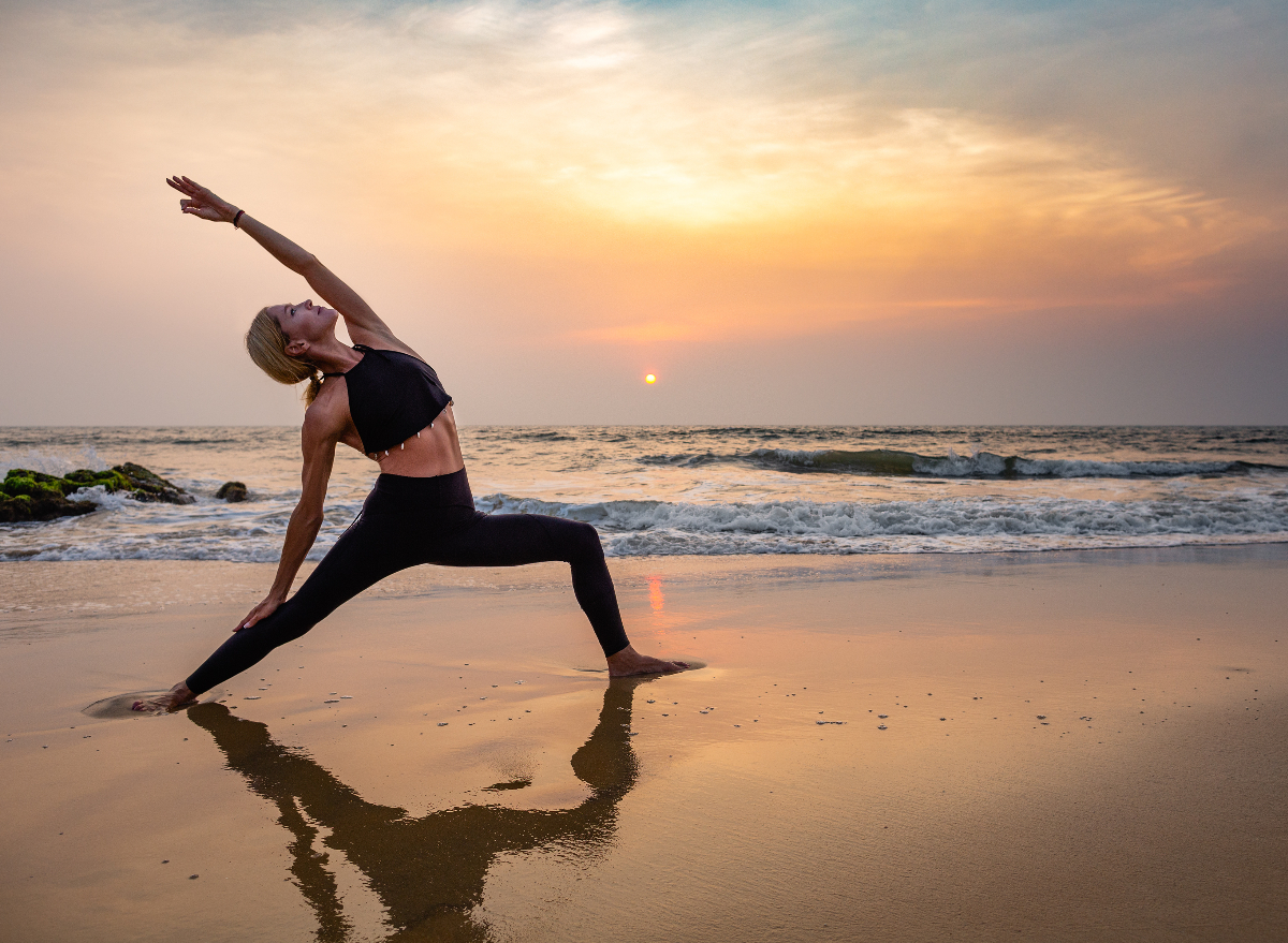 middle aged woman sunset yoga