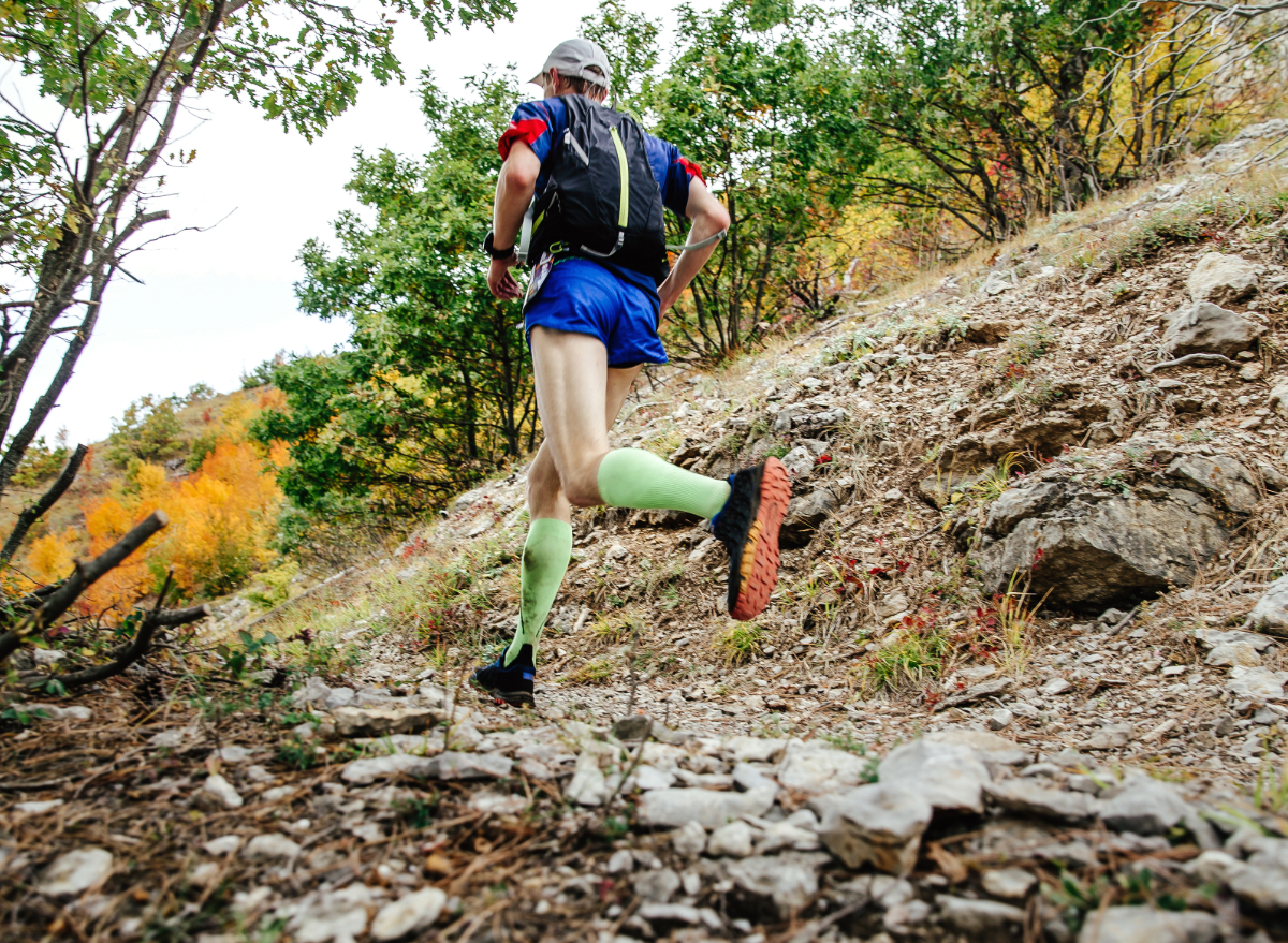 one jogs on the trail with a backpack