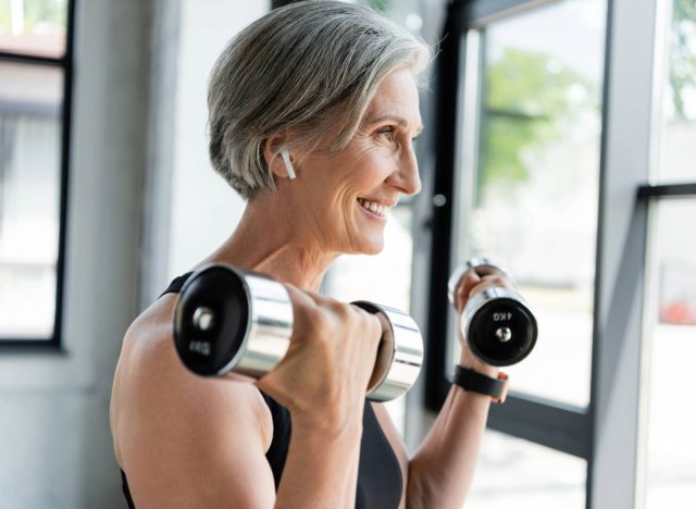 the best 30-day weight-loss workout for women after 50 75 happy woman lifting weights, concept of how many days a week to exercise for results