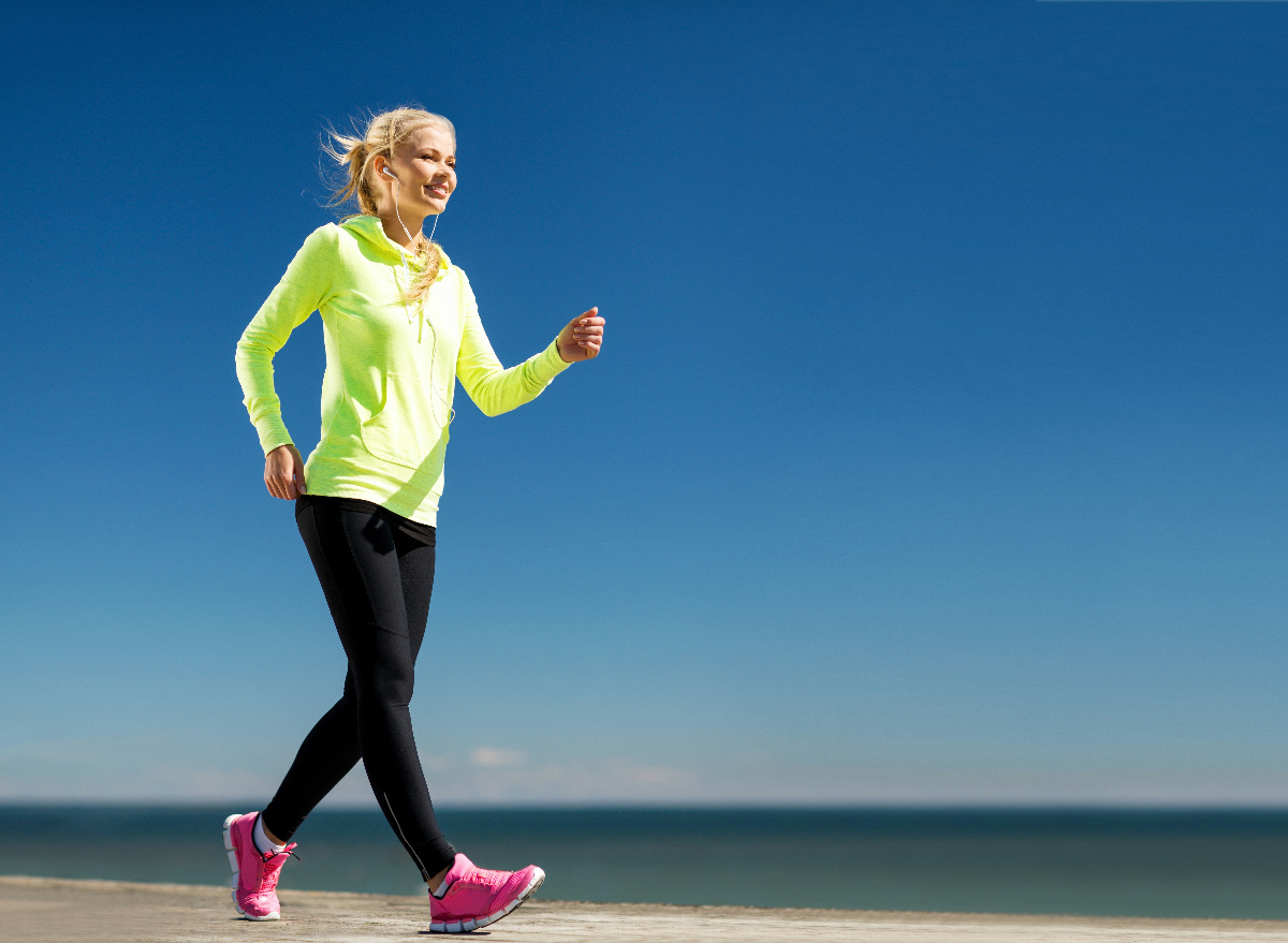 woman power walk by water