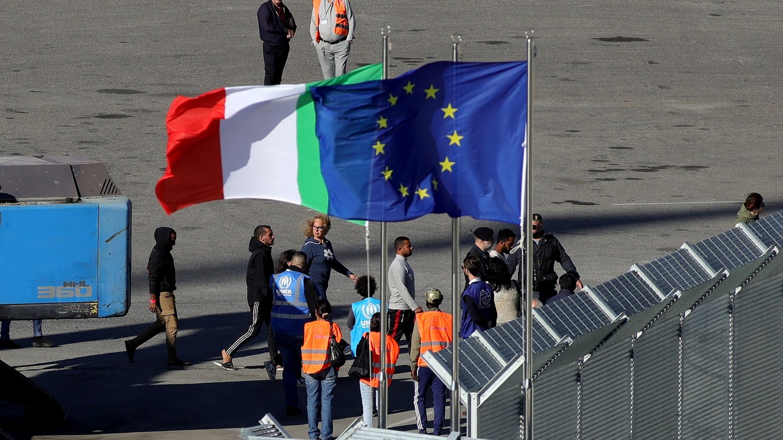 Italian navy brings first migrants to Albania centre