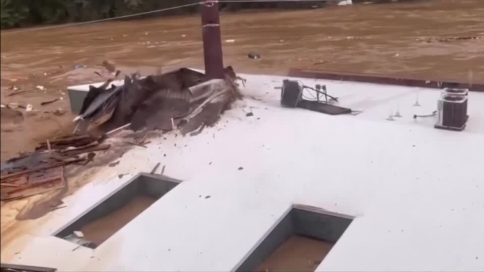 Watch: Moment building and container swept away as Helene leaves 210 dead