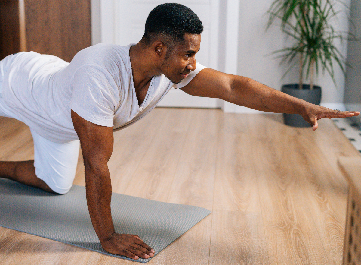 man performing yoga exercise, weight loss for men tips