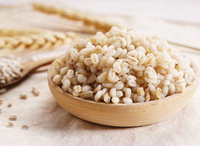 boiled barley in wooden bowl