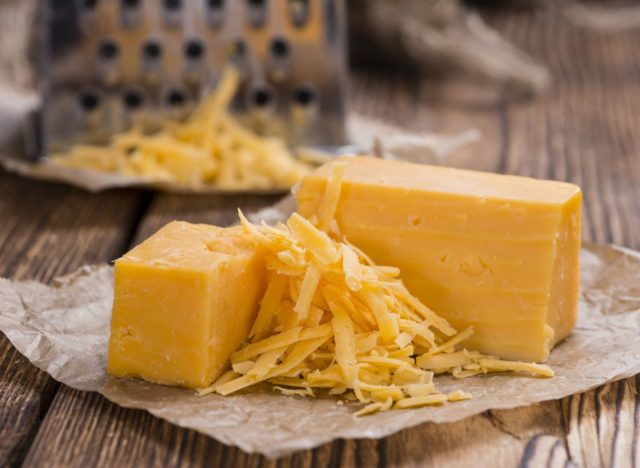 blocks of cheddar cheese and grated cheddar cheese