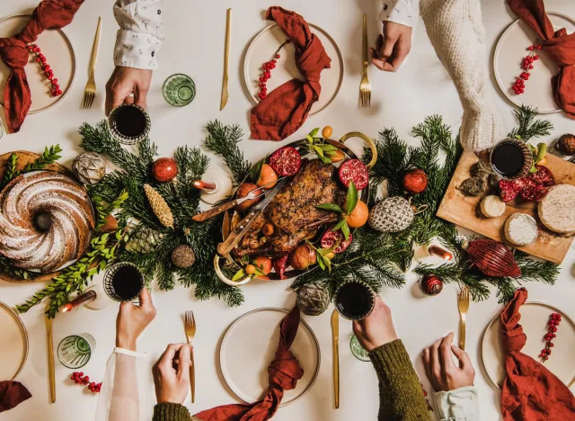 christmas table, people toast, concept with mindful holiday eating tips