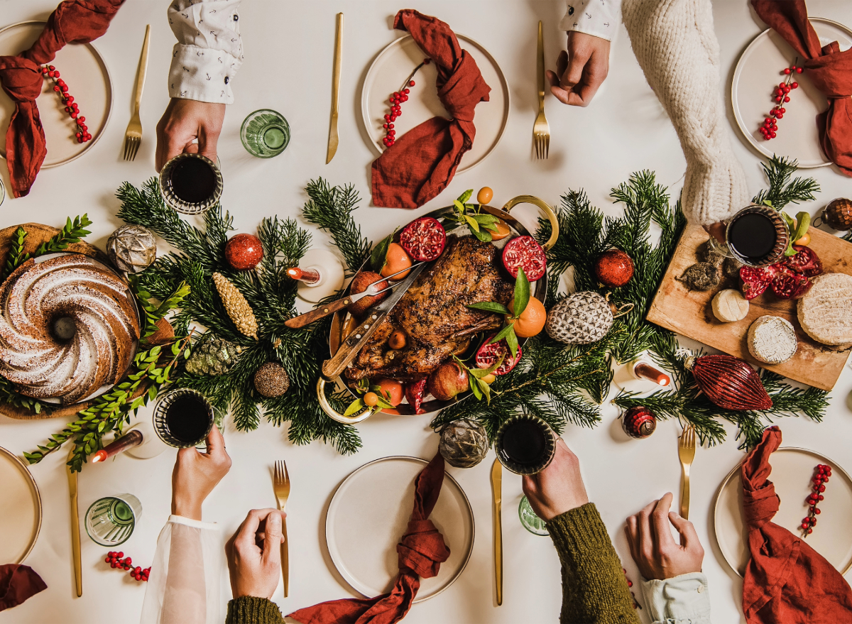 christmas table, people toasting, mindful holiday eating tips concept