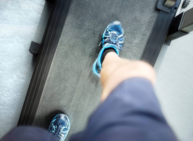 downward view of man looking down while treadmill running