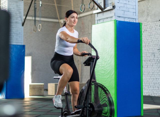 the two-week cardio exercise plan for shedding belly fat 63 woman on air bike, concept of machines for weight loss