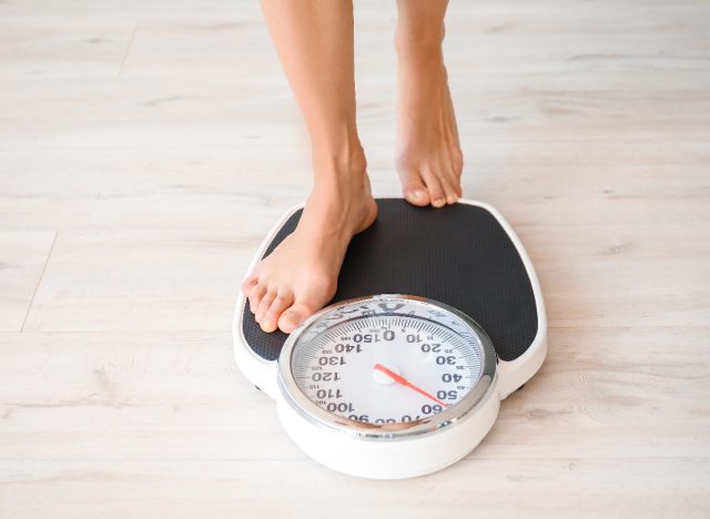 woman stepping on the scale