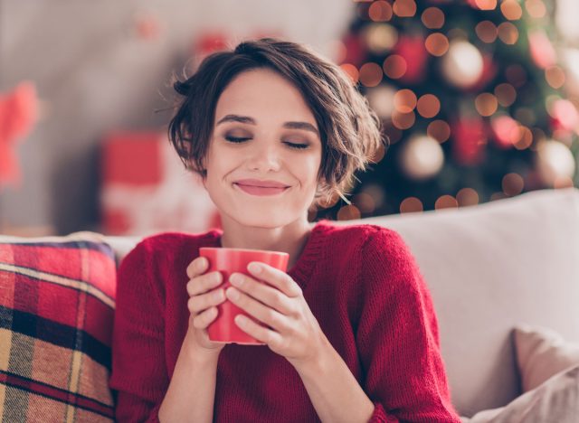 happy woman vacation coffee on sofa