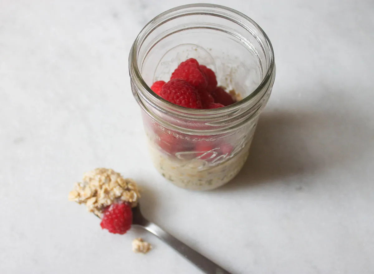 overnight oats finished with a spoonful of oats on the marble counter