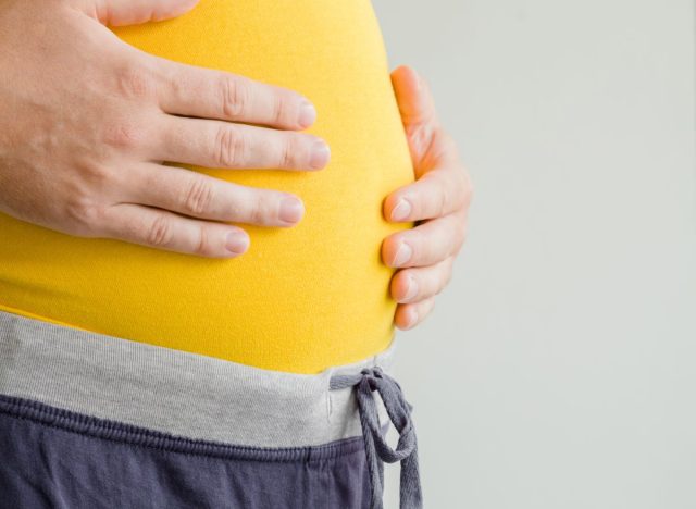 man feeling bloated holding stomach