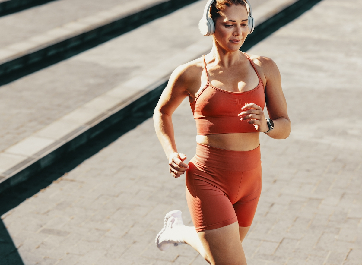 fit woman running outdoors, the concept of best exercises to melt belly fat