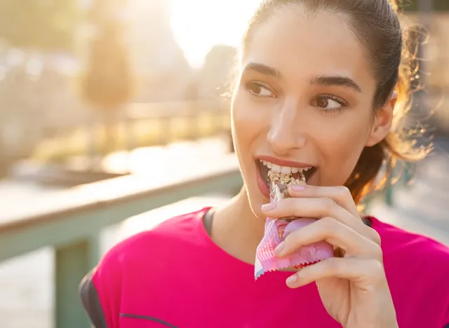 woman eating meal replacement bars