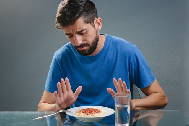 man showing lack of appetite