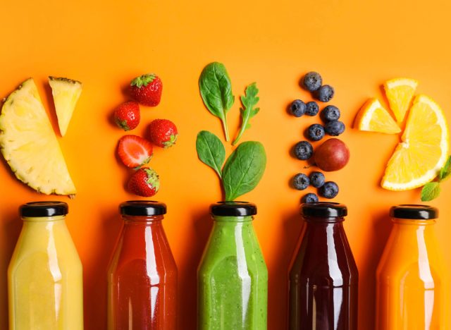 juice cleanse bottles on an orange background