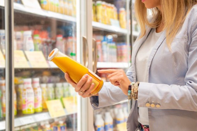 woman reading nutrition labels