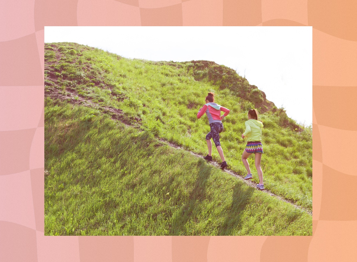 two friends walking uphill