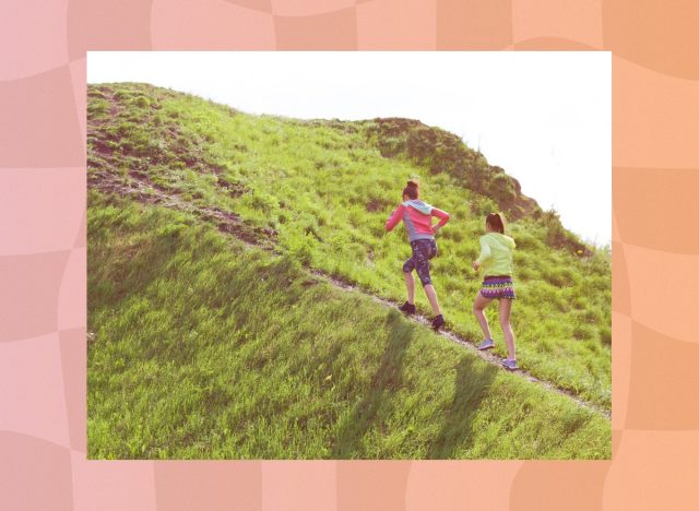 two friends walking uphill for exercise