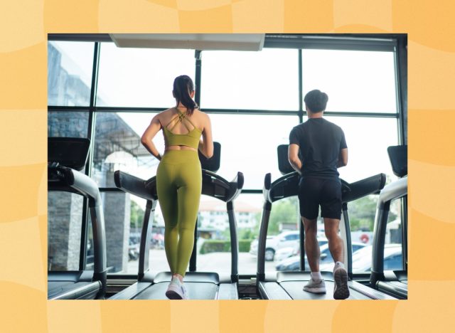 couple walking on treadmills at the gym