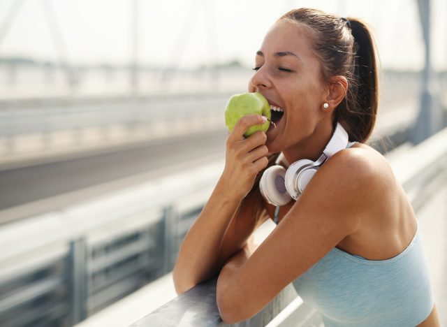 woman eating apple outside