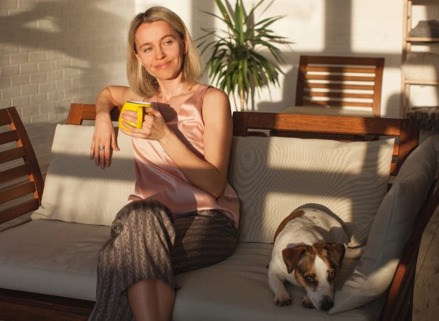 happy woman enjoying morning coffee, an important part of a health-conscious routine