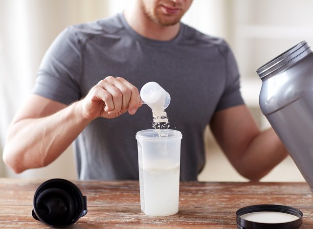 man pouring protein shake