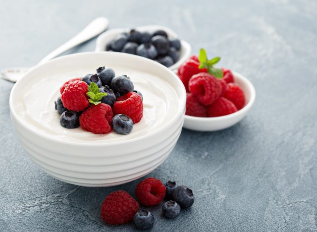 a bowl of creamy greek yogurt topped with berries