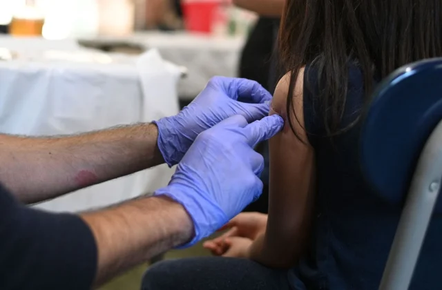 U.S. scales back universal guidance for four childhood vaccines, including flu
