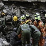 Seven trapped after 16-storey building collapses