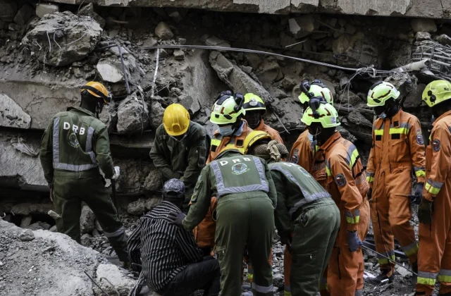Seven trapped after 16-storey building collapses